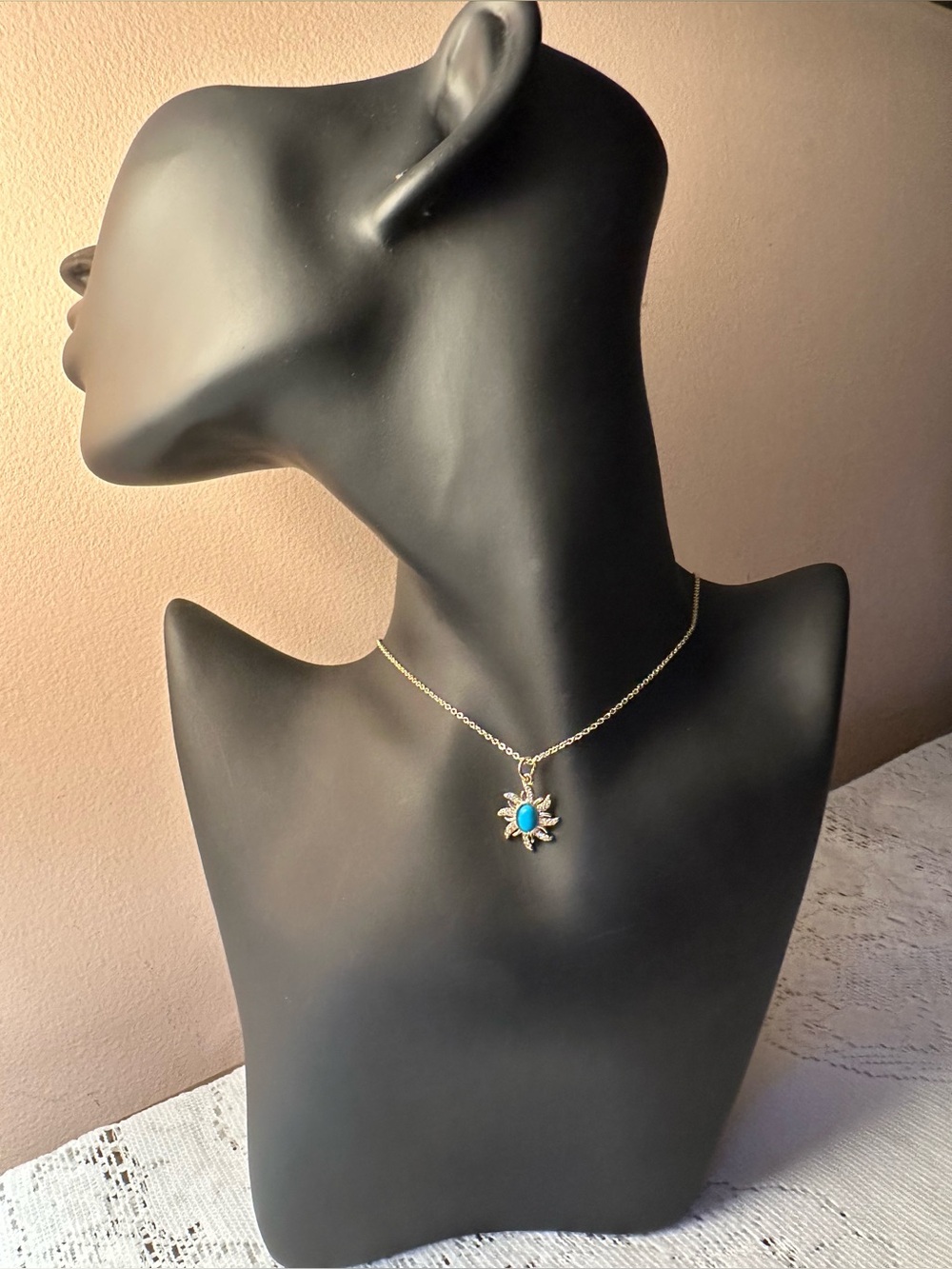 Adina Eden Gold tone Turquoise color pendant with sun ray design of CZ’s-18” ch